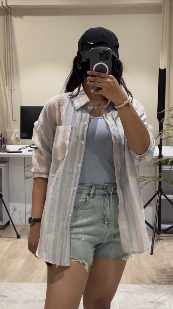 Casual Layered Outfit: Pink Button-Down Shirt, Tank Top, and Denim Shorts - Photo 2