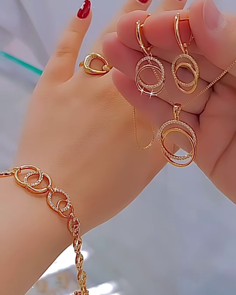 Elegant Rose Gold Tone Jewelry Set with Interlocking Circle Design and Sparkling Accents - Photo 2